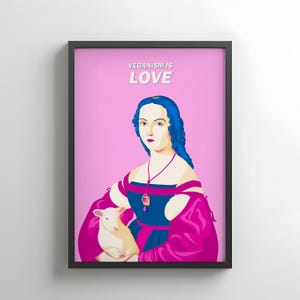 Puede incluir: Impresión artística enmarcada con una ilustración de estilo pop art. Una mujer con cabello azul y un vestido azul y rosa sostiene un cordero. El texto "VEGANISM IS LOVE" está en la parte superior sobre un fondo rosa.