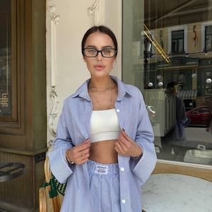 Summer Set: Striped Button-Down Shirt and Oversized Pants. Perfect for a vacation, street style, or a relaxed summer look.