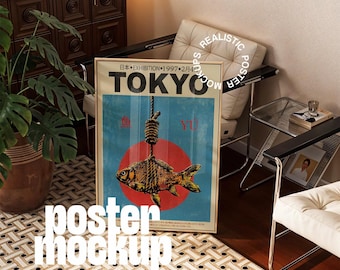 May include: A framed poster with the word "TOKYO" in large letters. The poster features a fish hanging from a noose against a red circle and blue background. The text "EXHIBITION 1997.2.4" is also visible. The poster is displayed in a room with a chair and a plant.