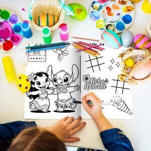 May include: A coloring book featuring Lilo and Stitch characters, with the text "Aloha Hawaii". The image includes colored pencils, paint, and decorated Easter eggs, suggesting a craft or activity theme.