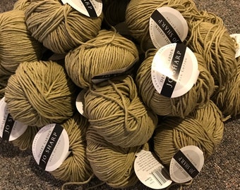 May include: A pile of beige yarn balls with white labels that read "Desert Garden Jo Sharp New Cotton".