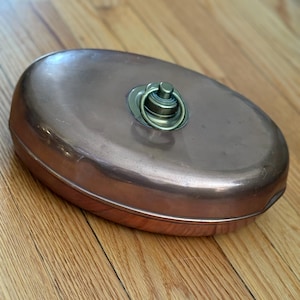 vintage copper bed warmer, hot water bottle or foot or bed warmer during cold nights by filling them with hot water or embers