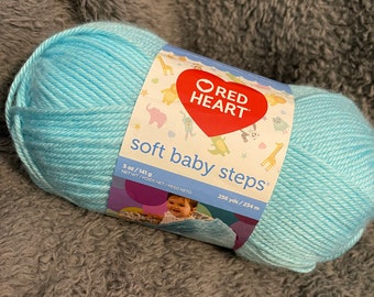 Yarn- red heart soft baby steps- color is aqua- 256yrds. Super soft.