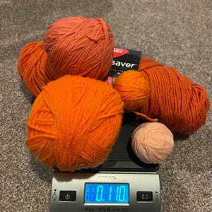 Yarn destash multi orange bundle skein plus solid.  Perfect for your imagination