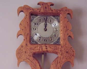 May include: A wooden clock with a carved design and a pendulum. The clock face has Roman numerals and a silver finish.