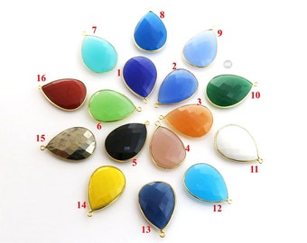 May include: Assortment of 16 teardrop-shaped gemstone pendants with gold-toned accents. The pendants are in various colors, including red, green, blue, yellow, black, white, and brown.