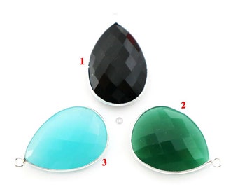 May include: Three teardrop-shaped pendants with silver settings. The pendants are made of black, green, and blue faceted glass.