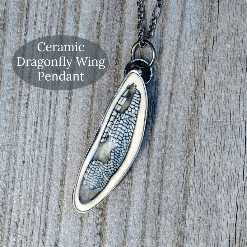 Handmade Ceramic Dragonfly Wing Pendant, in blue, encased in metal. Designed by Louisiana Artisans at Bayou Glass Arts in USA.