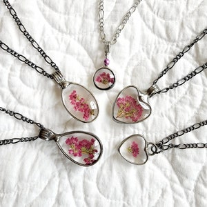large collection of Real Pressed Flower Pendant Necklaces in different shapes and sizes, rounds heart and ovals. Truly Hand Made in the USA by Louisiana Artisan at Bayou Glass Arts Studio. Quality glass not resin which can scratch and discolor.
