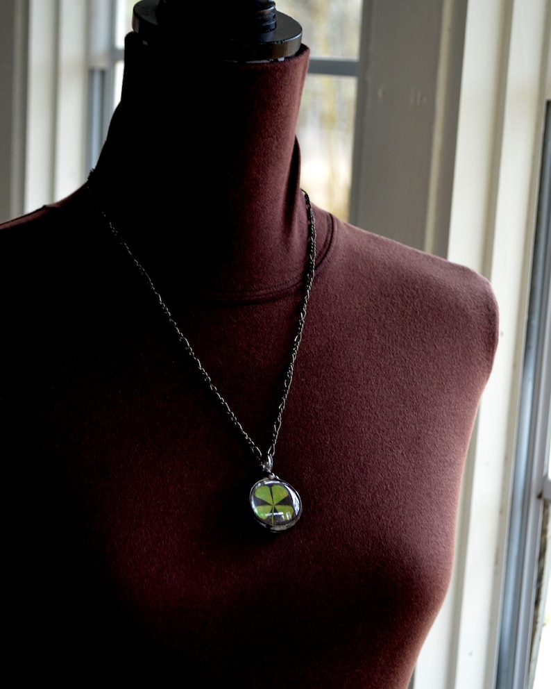 Model wearing Four Leaf Clover Pendant Necklace. Good Luck Charm. Terrarium pendant handmade by Artisans at Bayou Glass Arts. Best gift for March Birthday, wife, mother, girlfriend, Christmas, anniversary, St Patricks Day