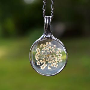 Delicate Queen Annes Lace Pendant Handmade by Louisiana Artisans at Bayou Glass Arts in USA. White Real Dry Pressed Flower under glass encased with gunmetal/shiny black/aged silver setting. Best gift for Christmas Anniversary Birthday Wedding Mom BFF