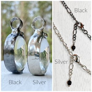 2 Bayou Glass Arts pendants side by side to show the difference in the finish. Left is gunmetal finish, right is shiny silver. The next image is of 2 Bayou Glass Arts necklace chains top is gunmetal finish, bottom is shiny silver finish.