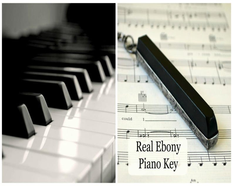 May include: Black and white image featuring a piano keyboard and a real ebony piano key. The key is rectangular with silver-colored metal edges and is resting on sheet music. The text "Real Ebony Piano Key" is also visible.