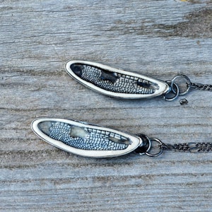 Two Handmade Ceramic Dragonfly Pendant on long necklace chain. Top is black, bottom is blue.