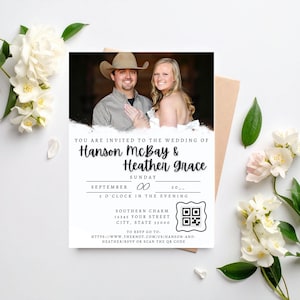 May include: Wedding invitation with a photo of Hanson McBay and Heather Grace. The invitation includes the date, time, and location, along with a QR code and website address. The design is white with black text and a rustic theme.