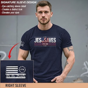 May include: A navy blue short-sleeve t-shirt featuring the white text JES USA VES with a US flag pattern on the U. The sleeve displays a white graphic of a flag with the text 1776 and We the People. The shirt includes the text 1776-2026.