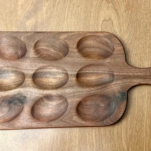 Puede incluir: Un juego de tres tazas de cerámica con un acabado mate moteado. Las tazas son de color crema, gris claro y gris oscuro. Cada taza tiene un diseño simple y minimalista.