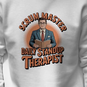 May include: White sweatshirt with a graphic featuring a cartoon image of a man in a suit holding a book. The text reads "Scrum Master Daily Standup Therapist" in orange and black.