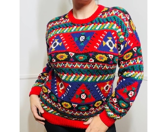 May include: A red, blue, green, yellow, and white patterned sweater with a crew neck.
