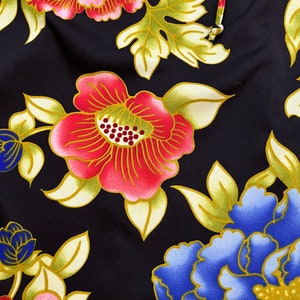 May include: Black fabric with a floral pattern featuring pink, red, blue, and gold flowers. The flowers are stylized and have a traditional Japanese design.