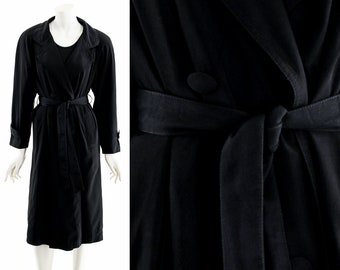 May include: A black long-sleeved trench coat with a belt and double breasted closure.