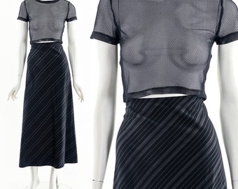 May include: A black mesh crop top with short sleeves and a black skirt with diagonal stripes.
