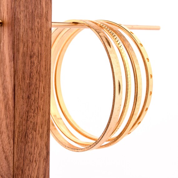 stack of gold bangles arm stack - image 8