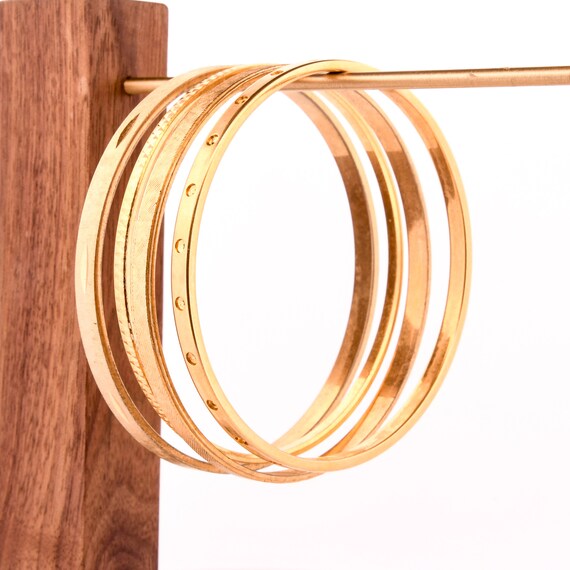 stack of gold bangles arm stack - image 2