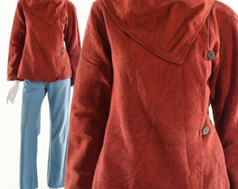 May include: A rust-colored, long-sleeved jacket with a large, folded collar. The jacket has a button closure and is made of a soft, textured fabric.