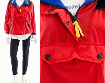 May include: Red, black, and blue windbreaker jacket with a zipper closure and a yellow drawstring. The jacket has a kangaroo pocket and a fleece-lined collar.
