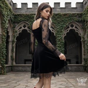 May include: A black velvet dress with long sleeves featuring intricate lace detailing on the sleeves and hem. The dress has a high neckline and a flared skirt, creating an elegant and gothic aesthetic. The background features a stone structure with climbing ivy.