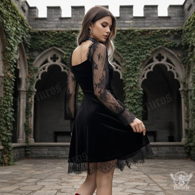 May include: A black velvet dress with long sleeves featuring intricate lace detailing on the sleeves and hem. The dress has a high neckline and a flared skirt, creating an elegant and gothic aesthetic. The background features a stone structure with climbing ivy.