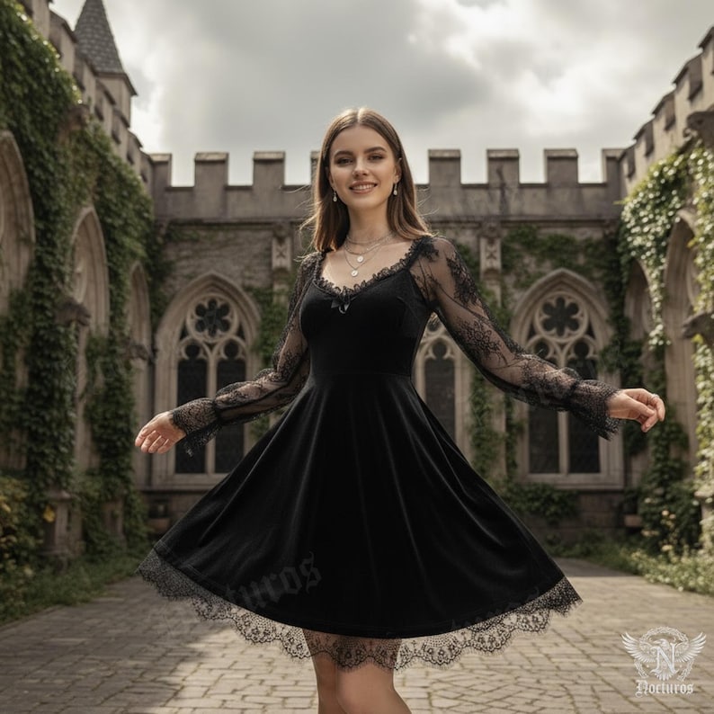 May include: A black dress with long, sheer lace sleeves and a lace-trimmed hem. The dress has a velvet bodice and a flared skirt. The background features a stone building with arched windows and climbing ivy. The dress is a gothic style.