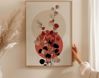 Op de afbeelding: Een ingelijste kunstdruk met een abstract botanisch ontwerp. Het kunstwerk toont gestileerde plantenstengels met rode, zwarte en beige bladvormen tegen een perzik- en beige cirkelvormige achtergrond. De print zit in een lichtbruine houten lijst.