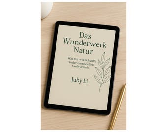 May include: A black tablet displays the cover of a book titled "Das Wunderwerk Natur" with text in German. The cover features a green leaf illustration and the author's name, Juby Li. A gold pen rests nearby.