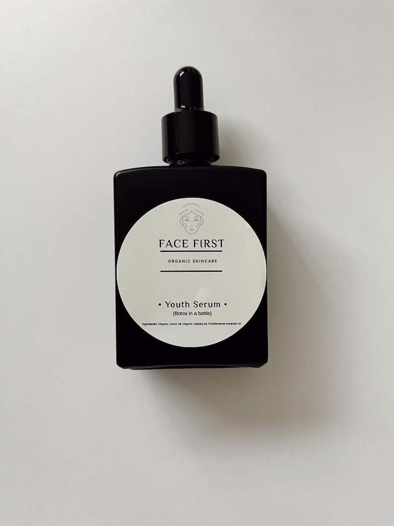 May include: A black square bottle of Face First Youth Serum with a dropper top. The white label features the brand name and the words "Youth Serum (Botox in a bottle)". The bottle is on a white background.