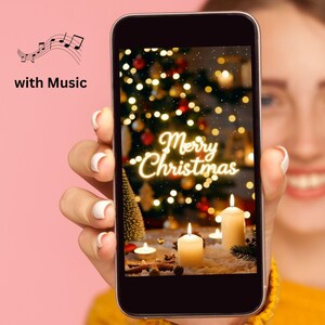 May include: A smartphone screen shows a Christmas scene with candles, a tree, and the words "Merry Christmas" in a glowing font. The phone is held against a pink background, with musical notes and the words "with Music" in the upper left corner.