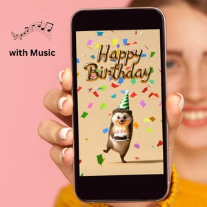 May include: A smartphone screen displaying a digital birthday greeting featuring a cartoon hedgehog wearing a green and white party hat, holding a small cake with lit candles, surrounded by colorful confetti and the gold text Happy Birthday.
