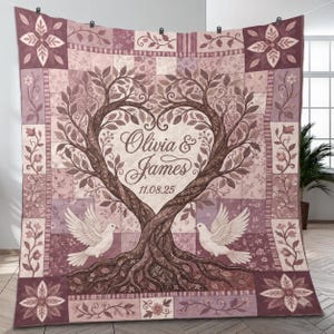 May include: A personalised quilt with a tree design and a heart-shaped canopy. The quilt is in shades of pink and brown, with the names "Olivia & James" and the date "11.08.25" displayed. Two white doves are perched on the tree branches. The quilt has a patchwork design.