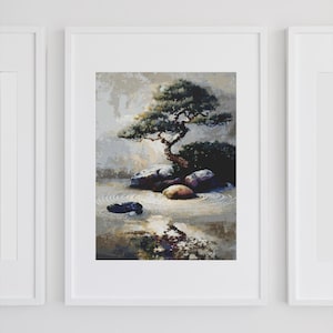 May include: Framed art print featuring a serene Japanese garden scene. The artwork depicts a bonsai tree, rocks, and water with concentric circles, all in muted tones. The print is displayed in a white frame, creating a minimalist aesthetic.