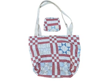 May include: A quilted tote bag and a matching small square pouch featuring a red and white gingham check pattern combined with blue and white star motifs. The tote has two long off-white fabric handles and a patchwork design throughout the exterior.