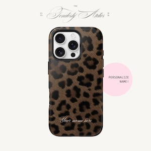 May include: A brown and black leopard print phone case with a black border. The case has a camera cutout and the text "Your name here" in cursive. A pink circle with the text "PERSONALIZE NAME!" is on the right.