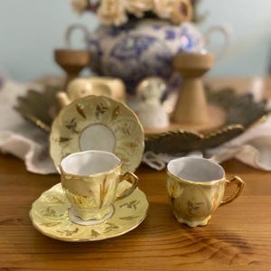 Elegant vintage espresso cup set made in Germany. With its golden appearance and fine porcelain craftsmanship, it is perfect for both coffee