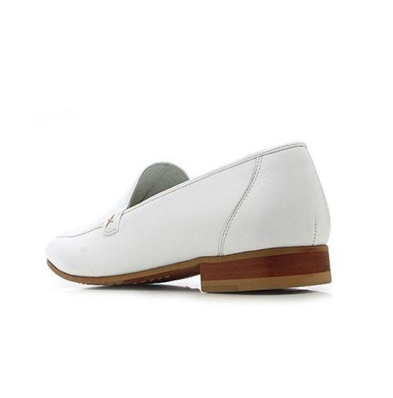 May include: White leather loafer with a brown sole and heel. The shoe features a classic slip-on design with a stitched upper and a small decorative accent near the vamp. The heel measures approximately 1 inch.