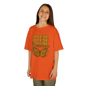 Jolene Dolly digital image with Jolene, Jolene, Jolene, Jolene written on it in gold and orange letters featuring butterflies and flowers.
Jolene Dolly T-shirt for Girls, Youth Music Tee, Dolly Shirt for Kids, Kids Graphic Top, Fan Gift, Cute Fan Gift, Graphic Top