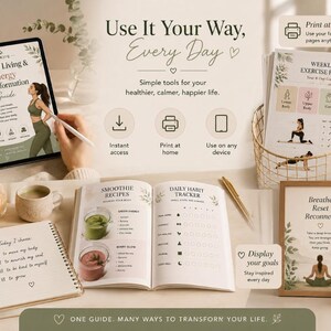 May include: A digital tablet displaying a Healthy Living & Energy Transformation Guide, a printed Weekly Exercise Plan in a wire basket, an open planner with smoothie recipes and a habit tracker, and a framed Breathe Reset Reconnect print.