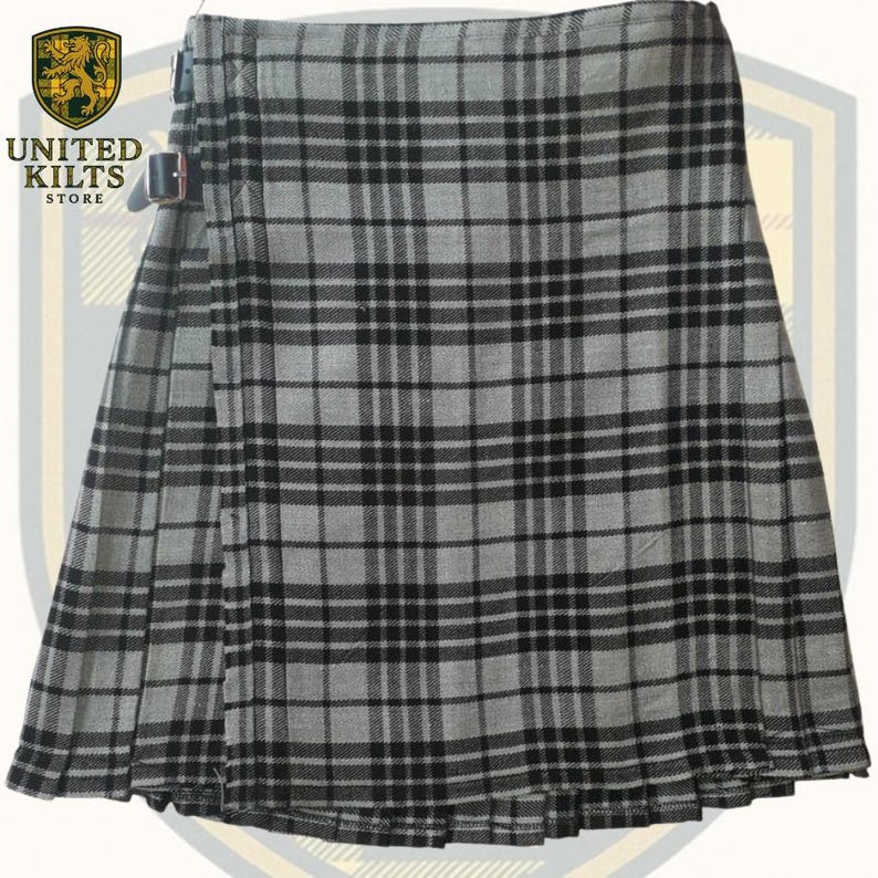May include: A gray and black plaid kilt with a buckle closure. The kilt features a traditional tartan pattern and is made of a woven fabric. The kilt is displayed on a white background. The United Kilts Store logo is visible in the upper left corner.
