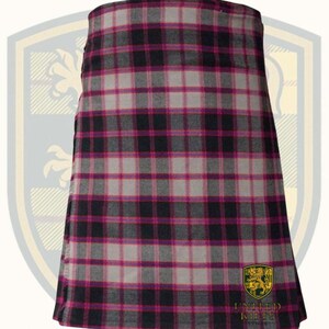 Puede incluir: Un kilt con un patr&oacute;n de cuadros en negro, gris y magenta. La tela est&aacute; tejida con un dise&ntilde;o tart&aacute;n tradicional. El kilt es una prenda que se lleva alrededor de la cintura, con pliegues en la espalda y una parte delantera plana.