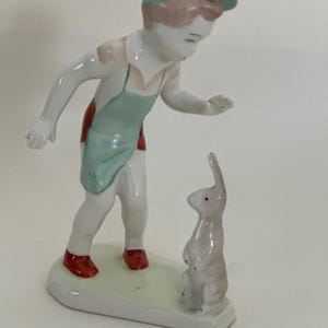 vintage glazed ceramic boy with rabbit figurine