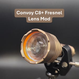 May include: A white ceramic mug with a black handle and the text "But First, Coffee" in a black, bold font. The mug is sitting on a wooden surface.